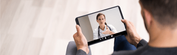 Man talking to a doctor using a tablet